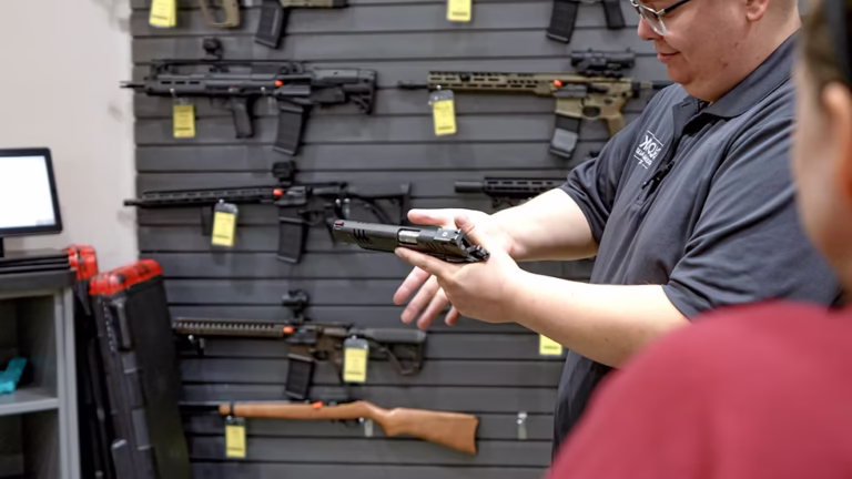 Firearms professional demonstrating how to safely handle a rifle at the counter