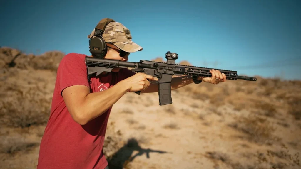 Shooter practising at an outdoor range wearing eye and ear protection
